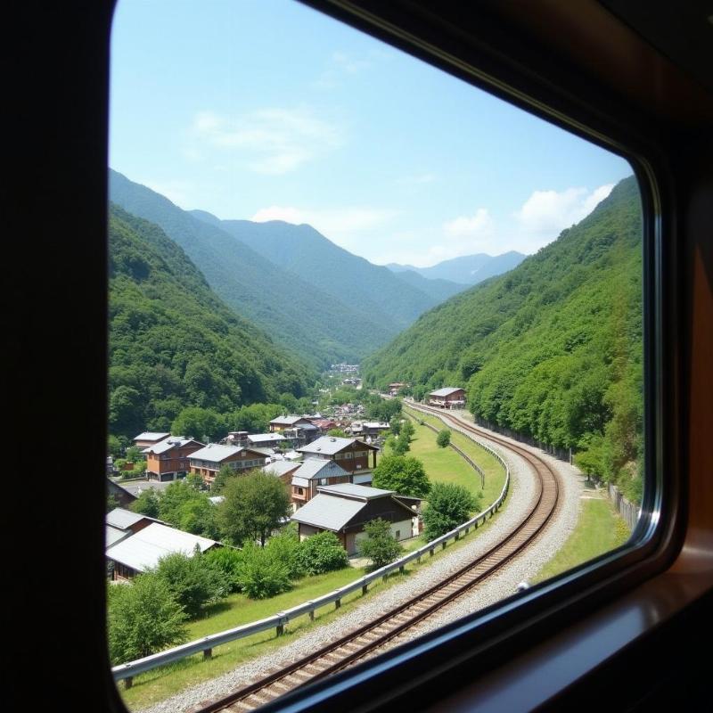 Cảnh đẹp trên đường đi đến Bảo tàng Nghệ thuật Ngoài trời Hakone bằng tàu, nhìn ra núi non xanh mướt và những ngôi nhà Nhật Bản truyền thống